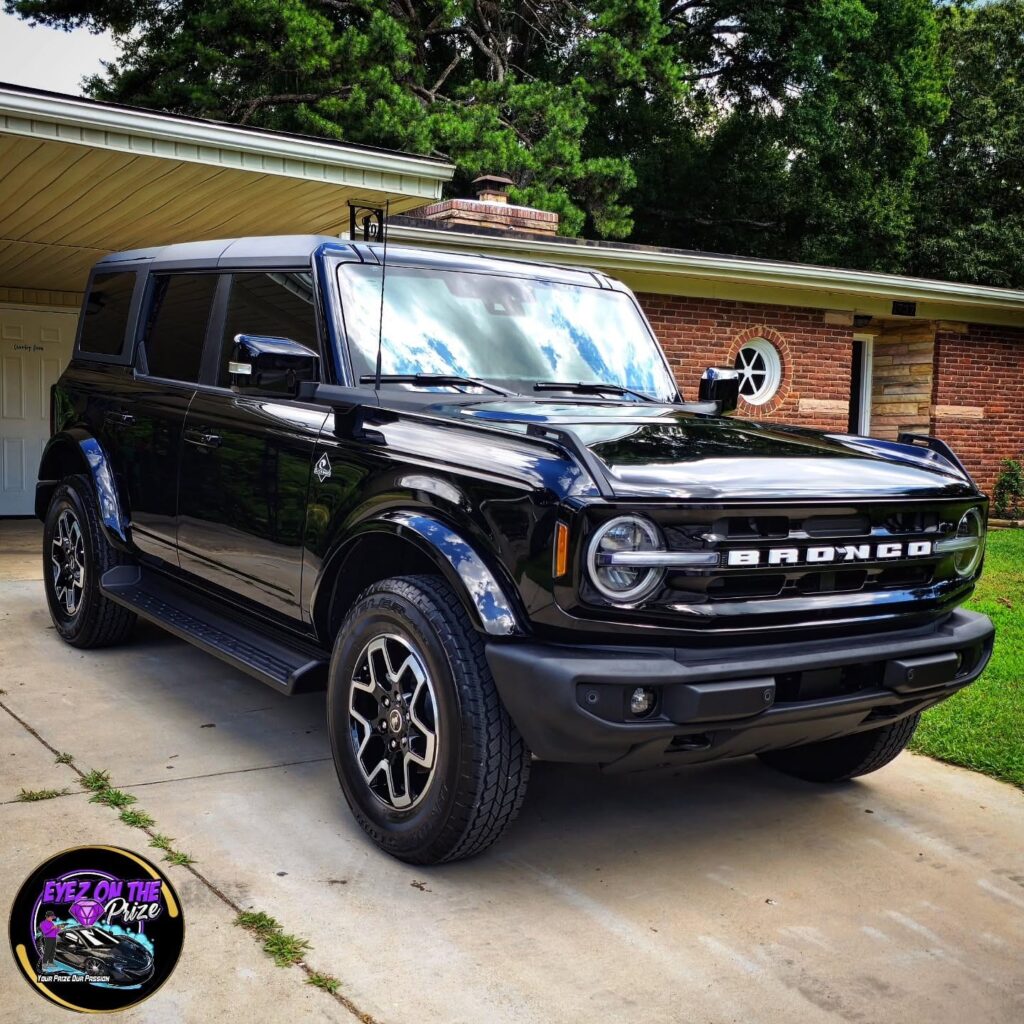 Black Ford Bronco with glossy paint parked on a residential driveway after detailing in Charlotte, NC