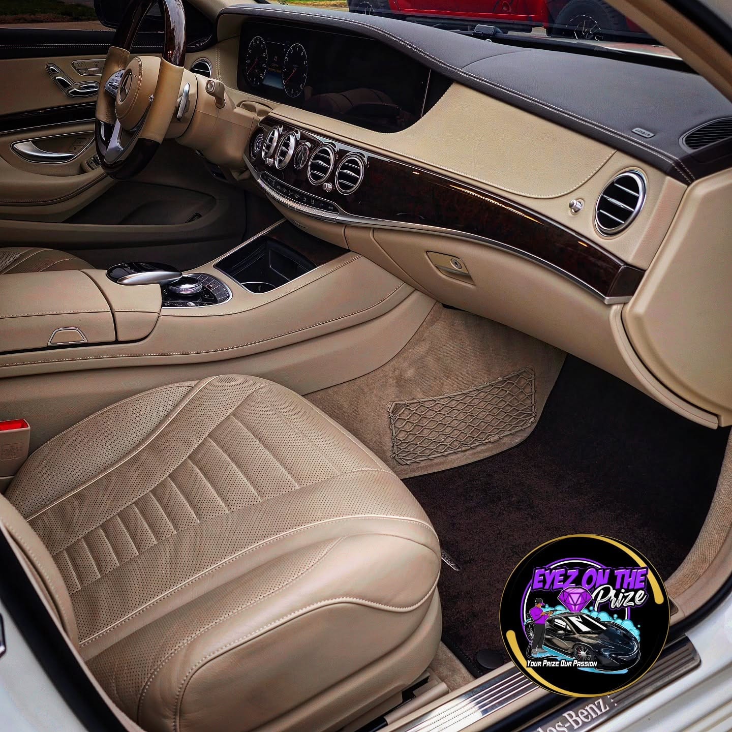 Cleaned tan leather front seats, dashboard, and carpet of a Mercedes S-Class after interior detailing