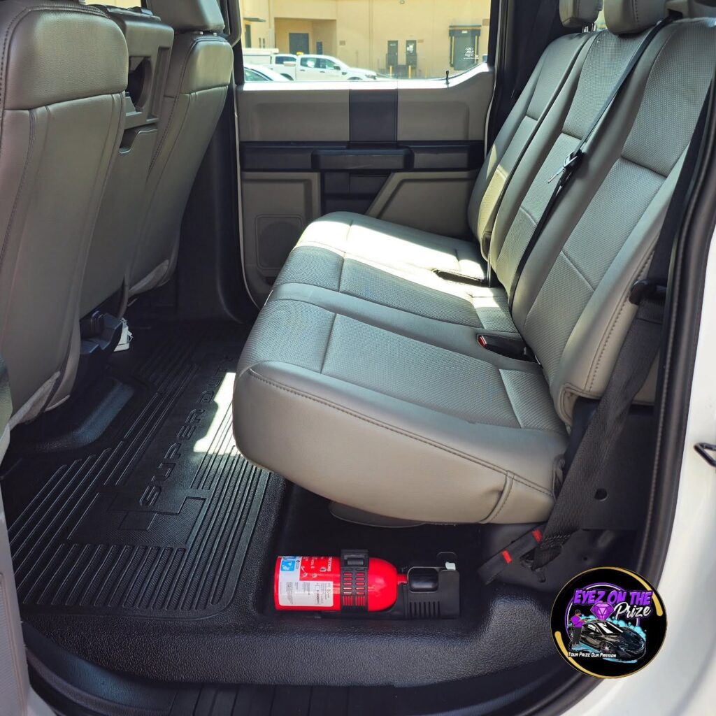 Cleaned gray leather rear bench seat and black Super Duty floor mats inside a Ford crew cab pickup.