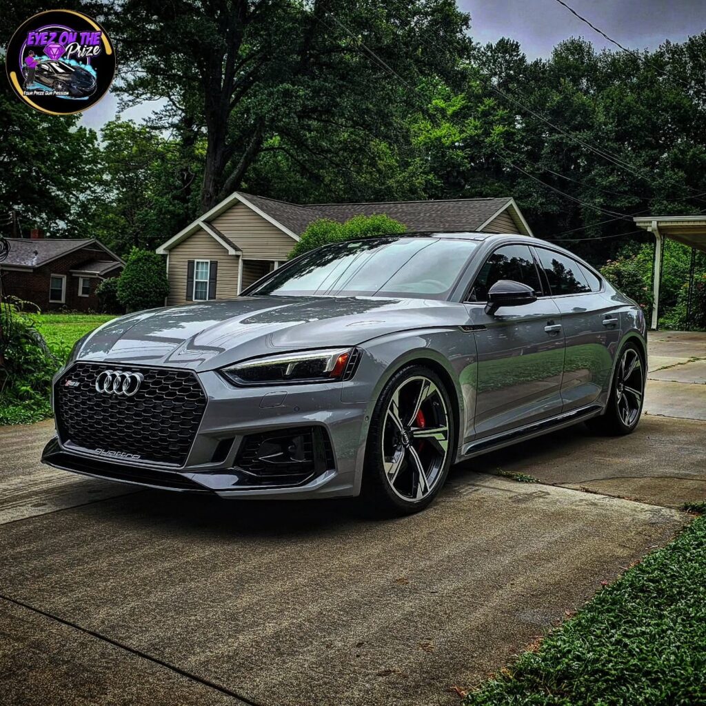 Gray Audi RS5 Sportback parked in a residential driveway after exterior detailing, front three-quarter view