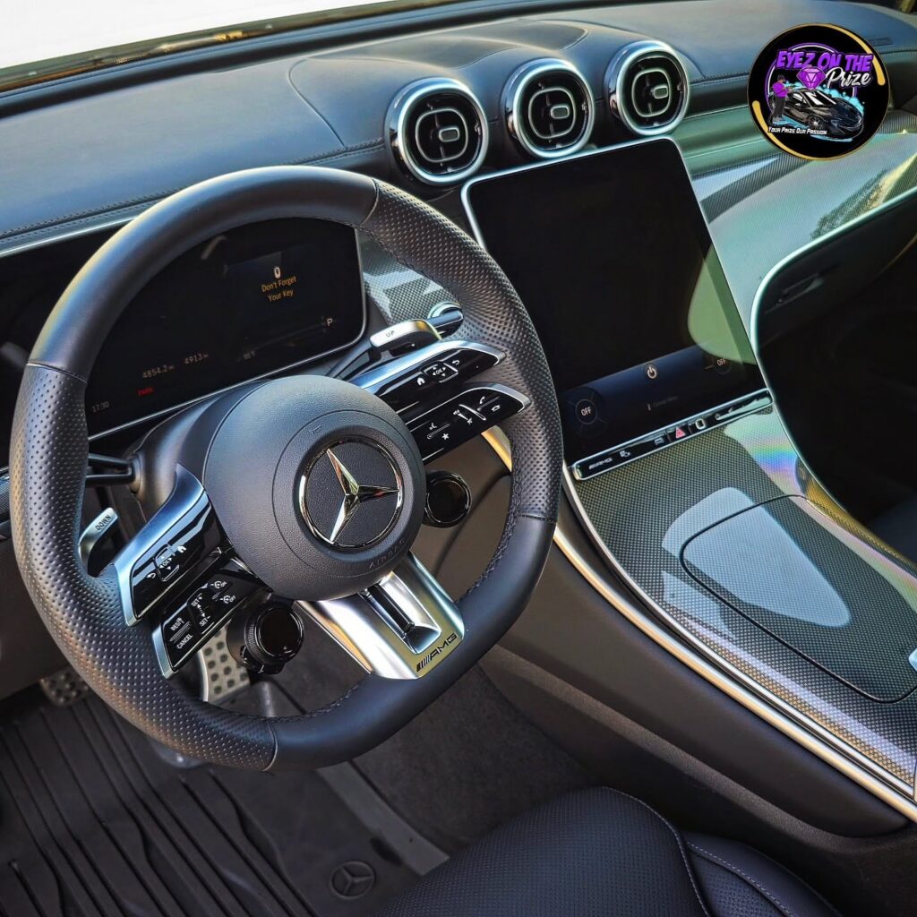 Mercedes-AMG steering wheel, dashboard, turbine vents, and touchscreen after interior detailing.