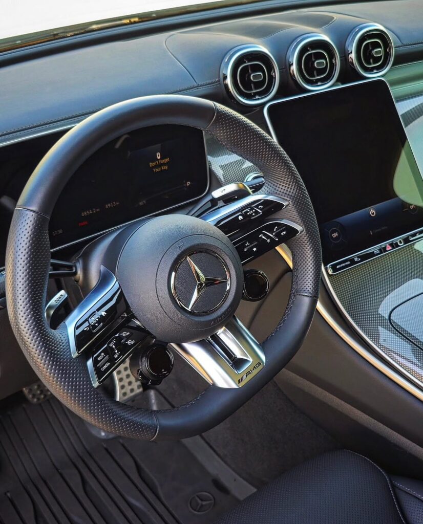 Mercedes-AMG steering wheel, dashboard, turbine vents, and touchscreen after interior detailing.
