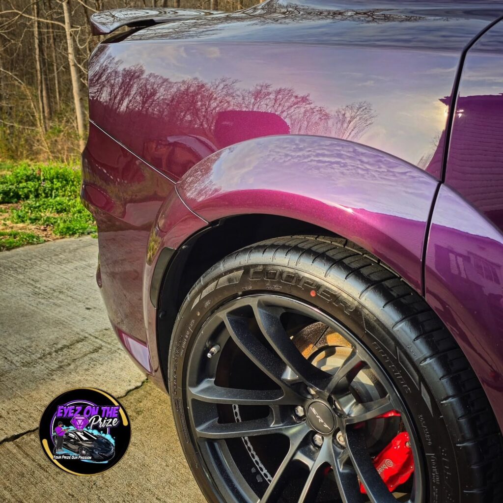 Close-up of a purple Dodge Charger widebody rear fender and SRT wheel with red Brembo caliper after detailing in Charlotte,