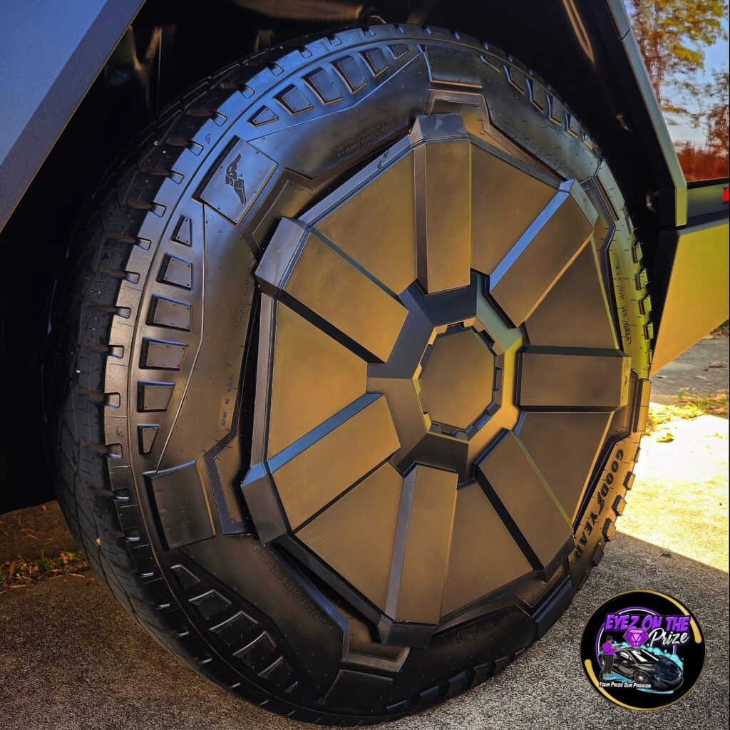 Close-up of a Tesla Cybertruck wheel with angular aero cover and cleaned Goodyear all-terrain tire