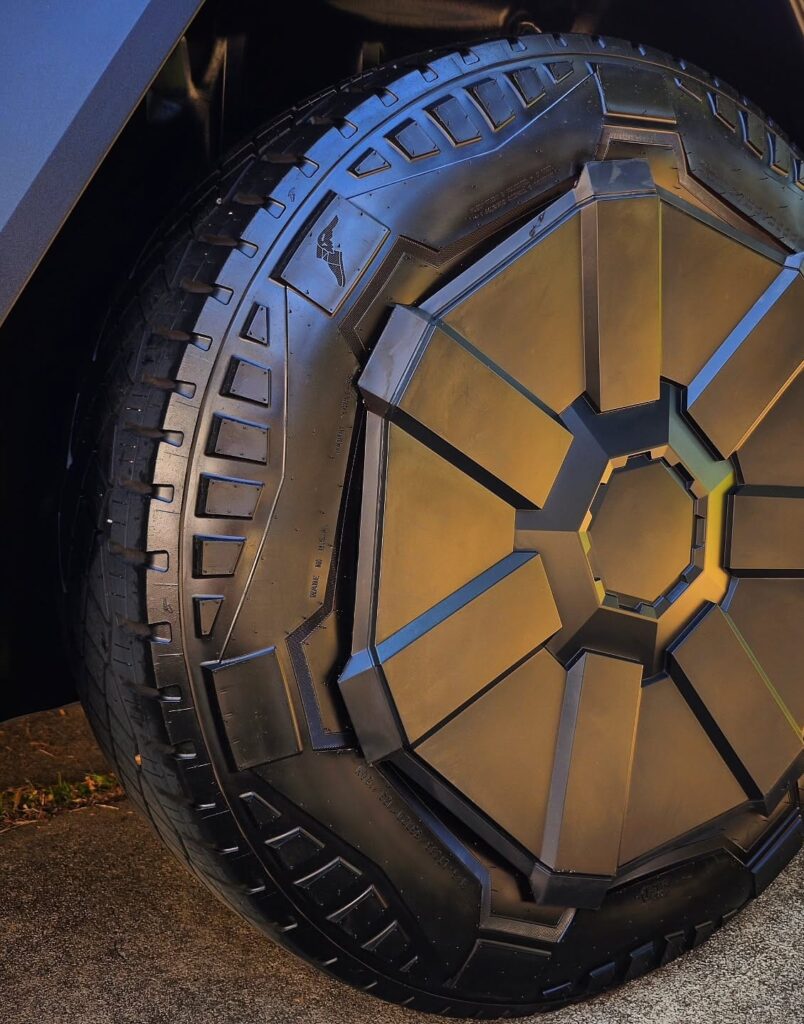 Close-up of a Tesla Cybertruck wheel with angular aero cover and cleaned Goodyear all-terrain tire