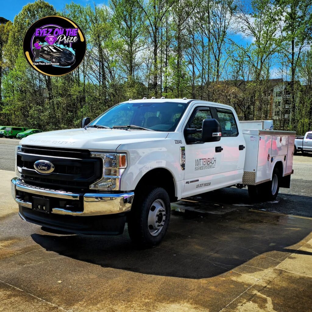 White Ford F-350 Super Duty crew cab with utility service body parked outdoors after exterior detailing in Charlotte, NC.
