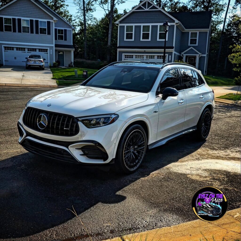 White Mercedes-AMG GLC SUV with black wheels parked on a residential street after detailing in Charlotte NC