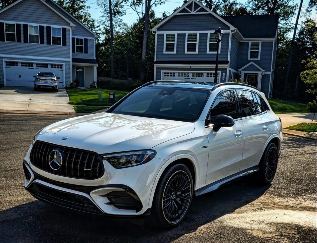 White Mercedes-AMG GLC SUV with black wheels parked on a residential street after detailing in Charlotte NC
